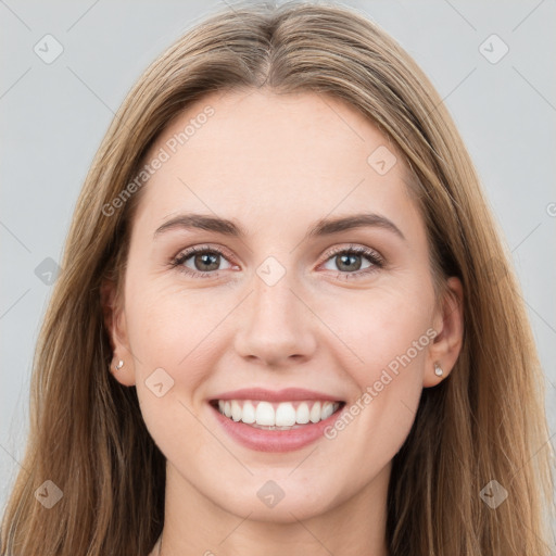 Joyful white young-adult female with long  brown hair and grey eyes