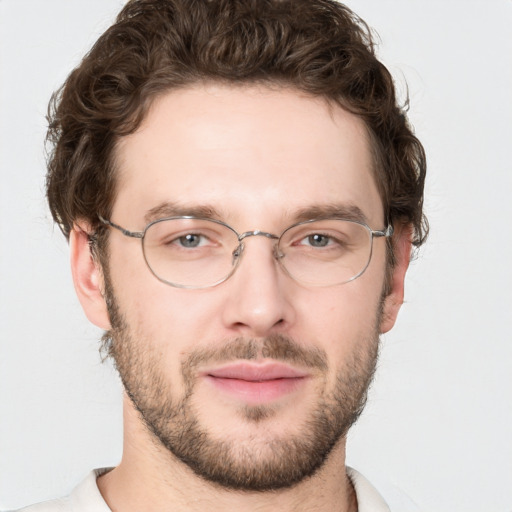 Joyful white adult male with short  brown hair and blue eyes