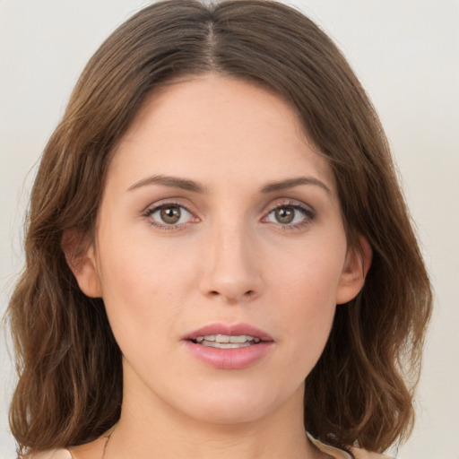 Joyful white young-adult female with medium  brown hair and green eyes