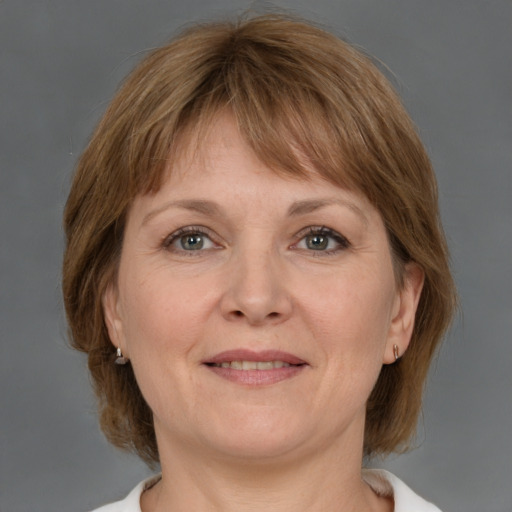 Joyful white adult female with medium  brown hair and grey eyes