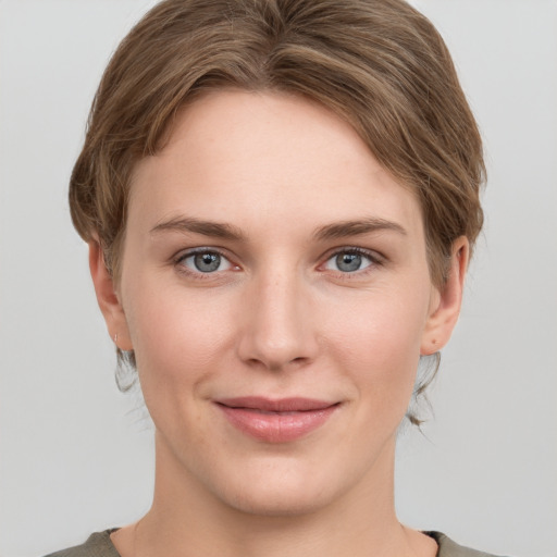 Joyful white young-adult female with short  brown hair and grey eyes