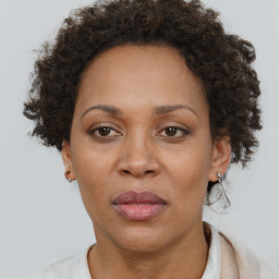 Joyful black adult female with short  brown hair and brown eyes