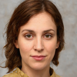 Joyful white young-adult female with medium  brown hair and green eyes