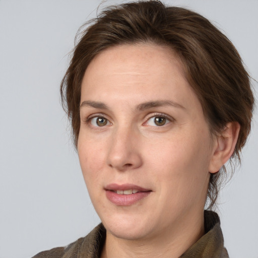 Joyful white adult female with medium  brown hair and grey eyes