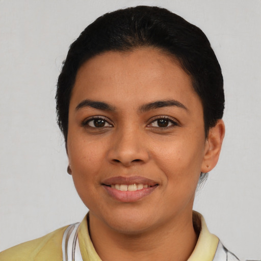 Joyful latino young-adult female with short  black hair and brown eyes
