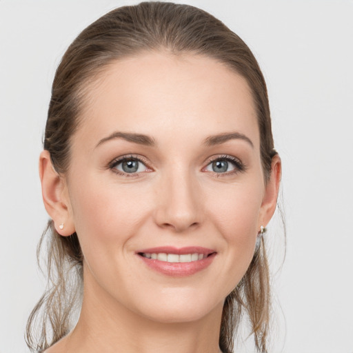 Joyful white young-adult female with long  brown hair and grey eyes