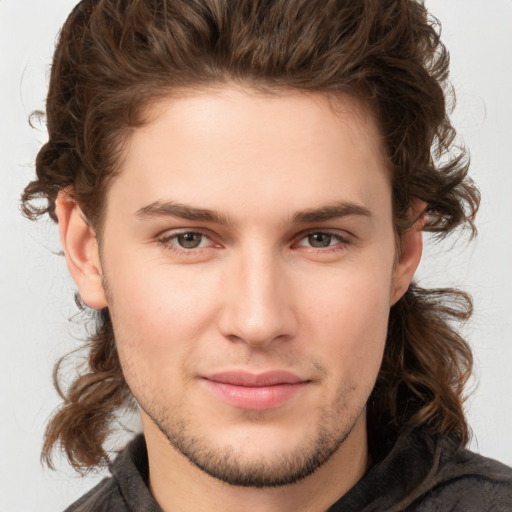 Joyful white young-adult male with medium  brown hair and brown eyes