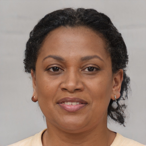 Joyful black adult female with short  brown hair and brown eyes