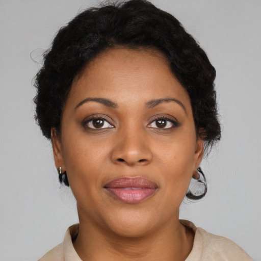 Joyful black adult female with short  brown hair and brown eyes
