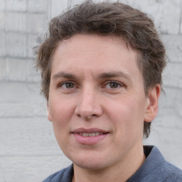 Joyful white adult male with short  brown hair and grey eyes