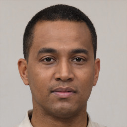 Neutral latino young-adult male with short  black hair and brown eyes