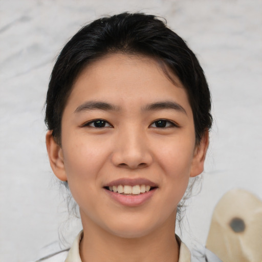 Joyful asian young-adult female with medium  brown hair and brown eyes