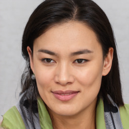 Joyful asian young-adult female with medium  brown hair and brown eyes
