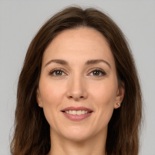 Joyful white young-adult female with long  brown hair and brown eyes