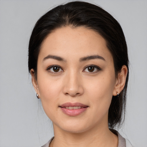 Joyful white young-adult female with medium  black hair and brown eyes