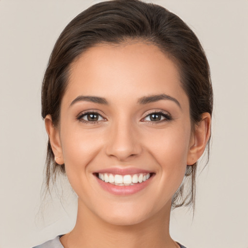 Joyful white young-adult female with medium  brown hair and brown eyes