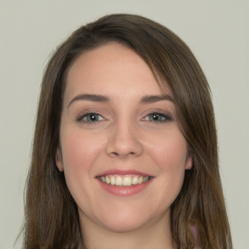 Joyful white young-adult female with long  brown hair and green eyes