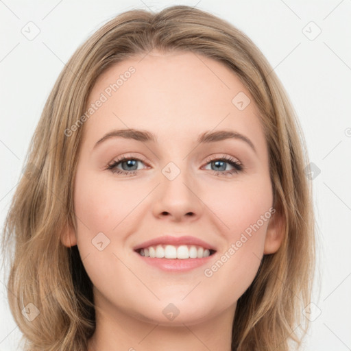 Joyful white young-adult female with long  brown hair and blue eyes