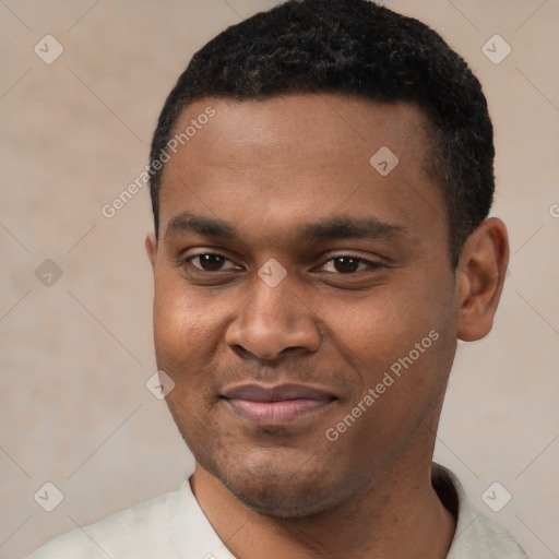 Joyful black young-adult male with short  black hair and brown eyes