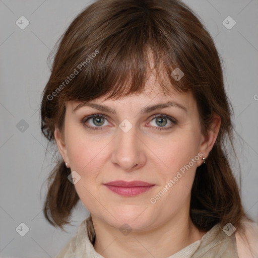 Joyful white adult female with medium  brown hair and grey eyes