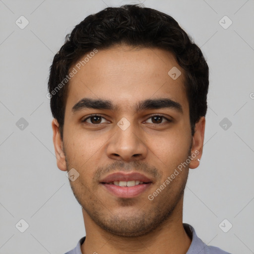 Joyful white young-adult male with short  black hair and brown eyes