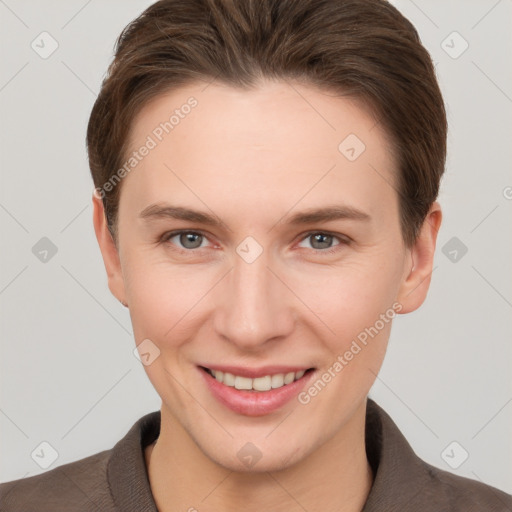 Joyful white young-adult female with short  brown hair and grey eyes