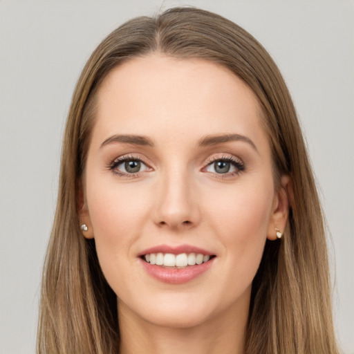 Joyful white young-adult female with long  brown hair and grey eyes