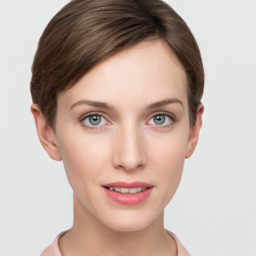 Joyful white young-adult female with short  brown hair and grey eyes