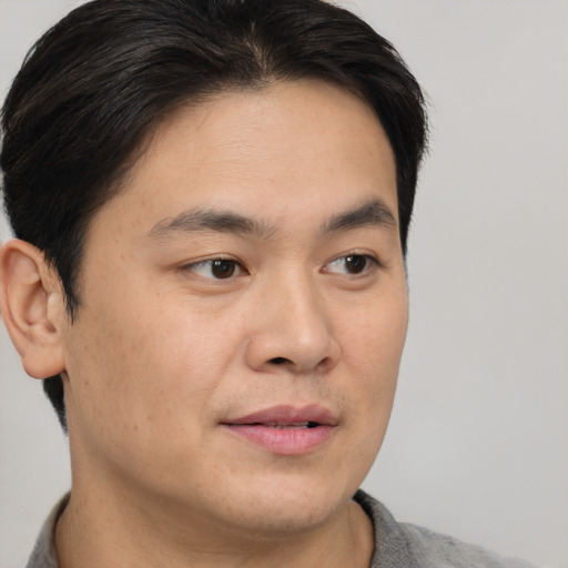 Neutral asian young-adult male with short  brown hair and brown eyes