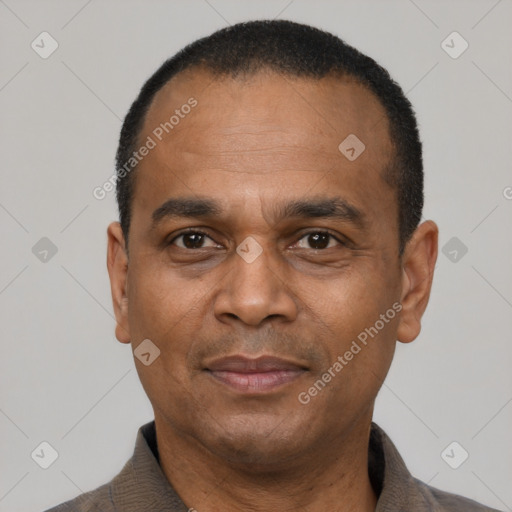 Joyful latino adult male with short  black hair and brown eyes