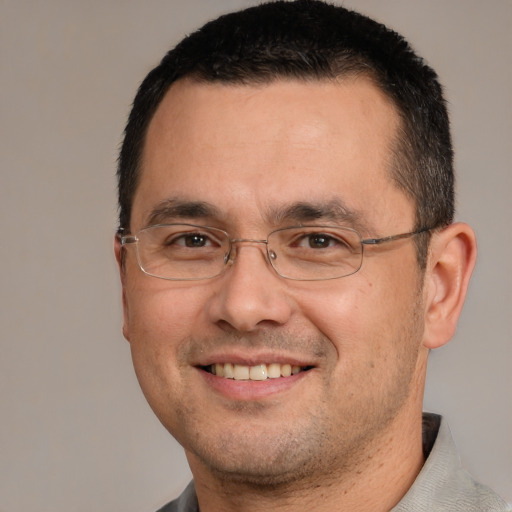 Joyful white adult male with short  brown hair and brown eyes