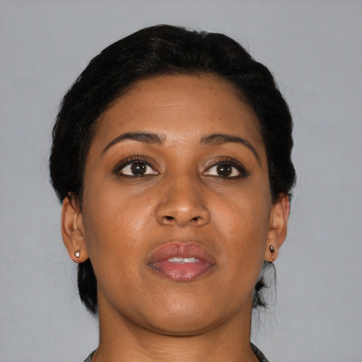Joyful black young-adult female with short  black hair and brown eyes