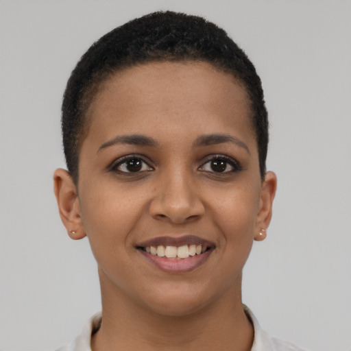 Joyful black young-adult female with short  brown hair and brown eyes