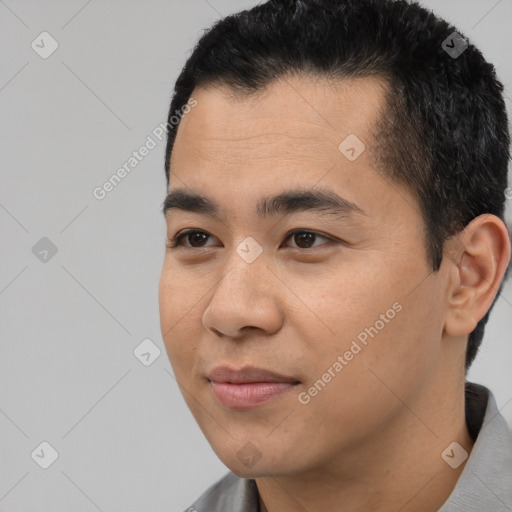 Joyful latino young-adult male with short  black hair and brown eyes