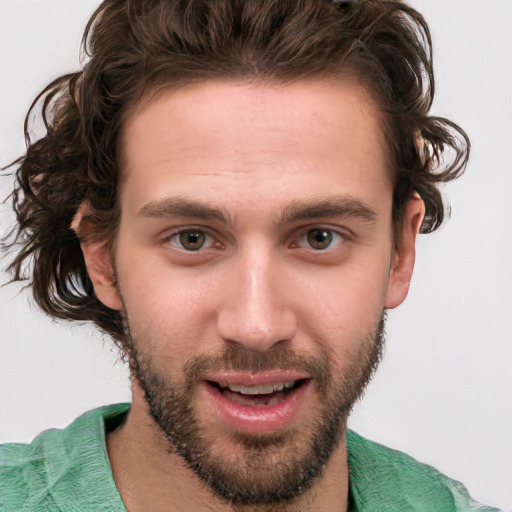 Joyful white young-adult male with short  brown hair and green eyes