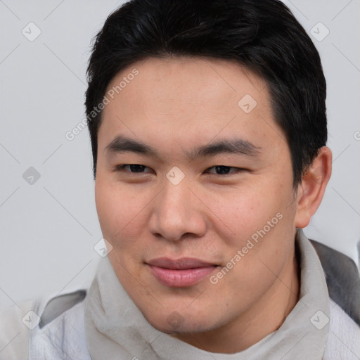 Joyful asian young-adult male with short  brown hair and brown eyes