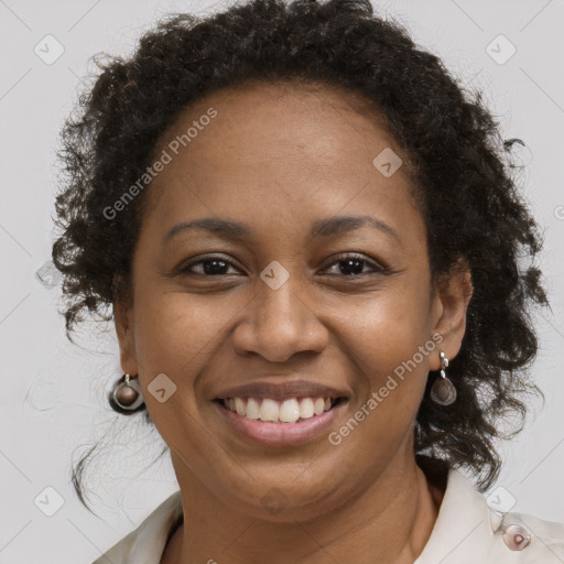 Joyful black adult female with short  brown hair and brown eyes