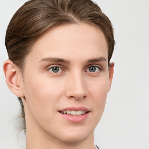 Joyful white young-adult female with short  brown hair and grey eyes