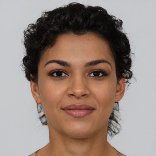 Joyful latino young-adult female with short  brown hair and brown eyes