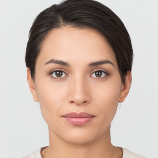 Joyful latino young-adult female with short  brown hair and brown eyes