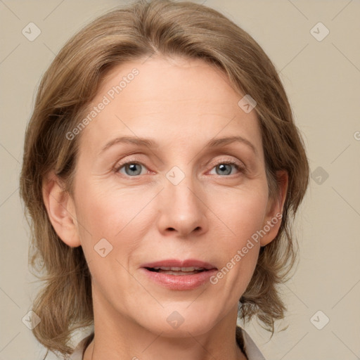 Joyful white adult female with medium  brown hair and grey eyes