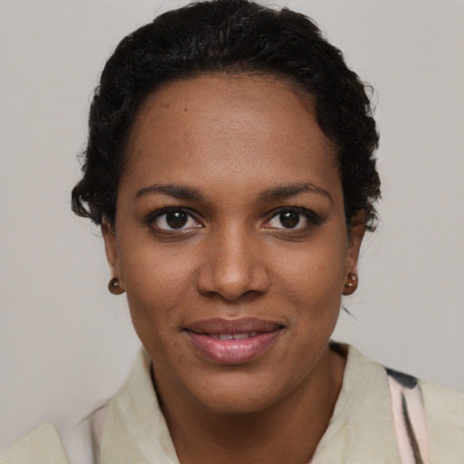 Joyful black young-adult female with short  brown hair and brown eyes