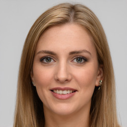 Joyful white young-adult female with long  brown hair and green eyes