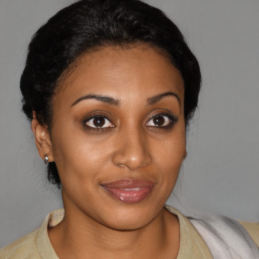 Joyful black young-adult female with short  brown hair and brown eyes