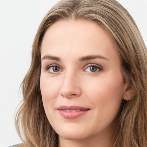 Joyful white young-adult female with long  brown hair and green eyes