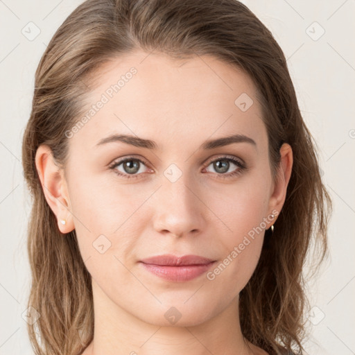 Joyful white young-adult female with long  brown hair and green eyes