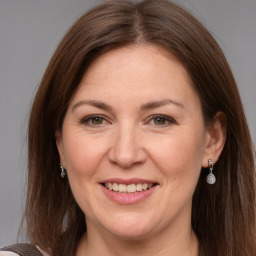 Joyful white adult female with medium  brown hair and grey eyes