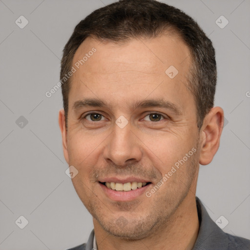 Joyful white adult male with short  brown hair and brown eyes