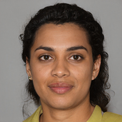 Joyful black young-adult female with medium  black hair and brown eyes