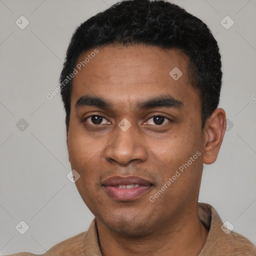 Joyful black young-adult male with short  black hair and brown eyes